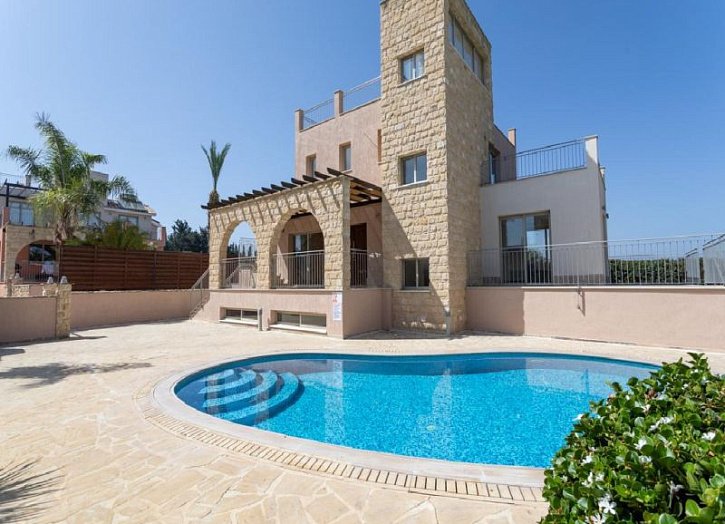 Villa in seafront development by beach